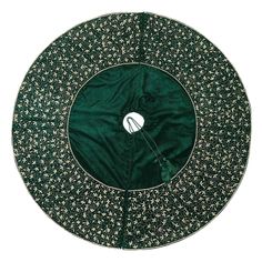 a green and white round table cloth with an embroidered flower design