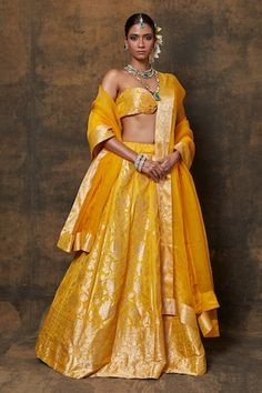 Yellow banarasi silk lehenga with woven zari floral jaal motifs. Comes with dupatta and unstitched blouse fabric. - Aza Fashions Designer Yellow Lehenga With Zari Weaving, Fitted Gold Sharara With Zari Weaving, Gold Chanderi Choli With Meenakari, Transitional Gold Brocade Lehenga, Fitted Gold Sets With Zari Weaving, Yellow Brocade Lehenga With Zari Work, Gold Choli With Zari Weaving For Reception, Designer Gold Choli With Meenakari, Silk Sets With Zari Weaving For Reception