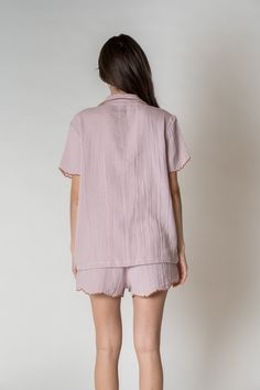 Sweet dreams happen in our Alaia Pajama Set! Made with 100% organic combed cotton, lightweight, comfy and sustainable. These PJs have a relaxed silhouette short sleeve, one chest pocket and are finished with a scalloped trim for a touch of sophistication. Upgrade your loungewear or gift these to someone special! Due to the fabrication process, there may be slight variations on the fabric. Features-Relaxed silhouette short sleeve-Button front-One chest pocket-Scalloped edges at the sleeve and bot Cotton Sleepwear With Pockets For Relaxation, Cotton Pajama Shorts With Pockets For Lounging, Relaxed Cotton Pajama Shorts, Cotton Sleepwear With Camp Collar For Loungewear, Spring Cotton Pajama Shorts For Relaxation, Summer Lounging Sleepwear With Pockets, Summer Sleepwear With Pockets For Lounging, Summer Cotton Pajama Shorts For Relaxation, Cotton Pajama Shorts For Summer Relaxation