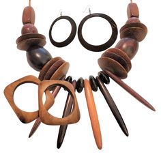 From the "Perfectly put together for you" collection! Mix matched pieces of pre-loved or vintage jewelry put together as a set ready to wear. Set includes a tribal bib style necklace with various shapes of chunky wooden beads, two wooden square-shaped bangle bracelets, and a pair of wooden hoop earrings. Earrings are dark wood and measure approximatley 2.75" in diameter. Bracelets measure about 2.5" on the inside and and 3.5" on the outside. Necklace is about 22" long. Excellent condition. Free Wooden Bead Jewelry, Afrocentric Jewelry, Bracelets Set, Wooden Hoop, Wood Necklace, Bead Jewelry, Wood Jewellery, Style Necklace, Wooden Jewelry