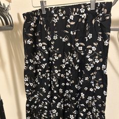 Black Skirt With White Floral Detail. Never Worn. Black Knee-length Skirt For Day Out, Black Floral Print Skirt, Casual Black Lined Maxi Skirt, Black Floral Print Maxi Skirt For Spring, Black Spring Vacation Maxi Skirt, Black Floral Print Flowy Skirt, Black Maxi Skirt For Spring Vacation, Black Flowy Floral Skirt, Black Floral Print Tiered Skirt