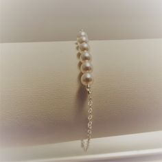 This dainty bracelet is made with six 4mm Swarovski creamy white pearls attached to a very sturdy sterling silver chain. Closes with a spring clasp. ~ALL metal is SOLID sterling silver (NOT Plated) and will last forever. ~Choose a length from the menu or add a note with the length you need ~High Quality chain & findings ~Packaged in a jewelry box MATCHING NECKLACE AVAILABLE HERE>> https://www.etsy.com/listing/204754453/sterling-silver-pearl-necklace-dainty Classic Sterling Silver Bracelet With Pearl Charm, Classic White Chain Bracelet With Pearl Drop, Pearl White Sterling Silver Bracelet With Round Beads, Elegant White Chain Bracelet With Pearl Drop, White Pearl Bracelet With Adjustable Chain, Elegant White Pearl Bracelet With Adjustable Chain, Sterling Silver Bracelets With Pearl Charm In Pearl White, Sterling Silver Pearl Bracelet With Pearl Charm, Pearl White Sterling Silver Bracelet With Pearl Charm