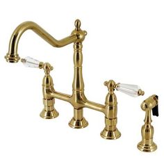 an antique brass faucet with two clear glass handles