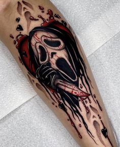 a man's leg with a tattoo on it that has a skull and blood dripping down the side