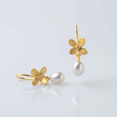 This is a pair of earrings from Dreamer Collection. It is a romantic and poetic pair of earrings that could be used daily or in a wedding party. The pearls are dangling and can have a slight sound when you make big moves. It is for dreamers who have the power to be where they want to be and to do what they want to do!  Available in 2 colors: Oxidized silver, silver and gold plated silver. The pearls are drop shaped high quality cultured pearls. Please indicate your phone number with your order. Classic Pearl Drop Flower Earrings Gift, Graceful Yellow Gold Earrings For Gift, Delicate Pierced Pearl Earrings As Gift, Contemporary Earrings, Wedding Jewelry Earrings, Pearl Drop Earrings, Gold Plated Silver, Cultured Pearls, Wedding Earrings