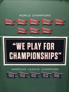 we play for championship stickers on the side of a green locker door with red and white lettering