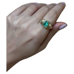 This exquisite 18-karat gold ring is centered with a natural emerald and paired with two natural trillion-cut diamonds, in a geometric stepped setting. The ring weighs just over 6grams of gold, giving it a luxurious feel. It's three stone design is timeless, and the setting of the stones allows the wearer to enjoy it on the daily as the stones are protected due to their bezel style setting. The Emerald is 1.50cts and the diamonds are 0.25cts each (Color G, Clarity VS/SI). This ring has been made in Cyprus, and can be resized to your desired size. If you would like to receive more photos or videos of this ring simply drop us a message and we will gladly forward these to you. We ship complimentary using DHL Express all across the world. 14k Gold Gia Certified Emerald Ring For May Birthstone, Gia Certified 14k Gold Emerald Ring For May Birthstone, Heirloom Green Baguette Cut Emerald Ring, Green Emerald Signet Ring For Wedding, Heirloom Green Diamond Ring With Baguette Cut, Gia Certified Gold Rings For May Birthstone, Heirloom Green Diamond Ring Baguette Cut, Heirloom Green Baguette-cut Diamond Ring, Heirloom Green Baguette Cut Diamond Ring