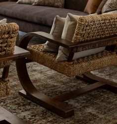 a living room filled with furniture and pillows on top of a carpeted floor next to a brown couch