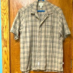 Very Handsome Button Down. New Without Tags Never Worn - Only Laundered. This Is A Sturdy Attractive Breathable Cotton Fabric That Looks Expensive. The Color Is Tan With A Denim Blue In The Plaid Pattern. Casual Plaid Button-up Camp Shirt, Brown Collared Top For Casual Gatherings, Casual Brown Button-up Camp Shirt, Casual Beige Button-up Short Sleeve Shirt, Casual Brown Camp Shirt With Button Closure, Casual Brown Short Sleeve Shirt With Buttons, Tan Plaid, Denim Blue, Plaid Pattern