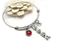 PLEASE JOIN MY NEWSLETTER TO GET YOUR SPECIAL 20% OFF DISCOUNT CODE. Please copy and paste the following link, which will take you to your coupon code http://eepurl.com/dIV_vH,  This listing is for one Stainless Steel Personalized DNA Bracelet with Hand Stamped Initial Charm of Your Choice and a crystal birthstone of your choice. This stainless steel  DNA charm bangle measures approximately 60 mm in diameter. DNA Double Helix Charm Bracelet will be a great biology teacher gift, or science teache Dna Bracelet, Biology Teacher Gifts, Dna Jewelry, Science Teacher Gifts, Biology Teacher, Double Helix, Split Rings, Science Teacher, Code Promo