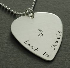 a guitar pick with the words lost in music written on it