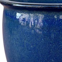 a large blue pot is shown on a white background, with the bottom part of the planter visible