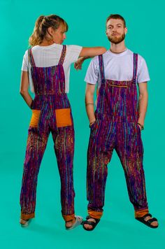 Unisex Overalls, African Dungarees, Rainbow Overall, Festival Dungarees These gorgeous purple striped dungarees are all you need to add some pazazz to every day. All of our festival dungarees are unisex and feature loads of pockets and a cool turn-up leg that can be adjusted to your size. What's not to love? Grab yourself a pair and dance your way through life!  - Fun and funky dungarees - Lined in orange cotton fabric - Easily adjusted to your height/ size (turn-ups bottoms/ adjustable straps o Fitted Multicolor Jumpsuits And Rompers With Pockets, Multicolor Cotton Overalls For Festival, Traditional Multicolor Festival Pants, Pride Overalls, Festival Multicolor Cotton Overalls, Multicolor Festival Overalls, Multicolor Patchwork Overalls, Unisex Overalls, Hippie Overalls