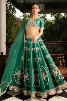 Green lehenga with embroidered tree motifs all-over and patchwork. Comes with blouse and net dupatta.
Components:3
Pattern:Embroidery
Type of Work:Sequin, Pearl and Stone
Neckline:V neck
Sleeve Length:Half
Fabric:Raw Silk and Net
Color:Green
Other Details:
Cutout at the back
Asymmetrical blouse hem
Dupatta with pearl border
Closure: Side zip
Occasion:Bride - Aza Fashions Brocade Skirt, Green Lehenga, Blue Lehenga, Lehenga Online, Lehenga Skirt, Embroidered Lehenga, Asymmetrical Blouse, Silk Bottoms, Indian Lehenga