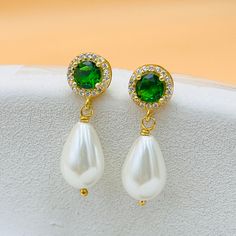 ✨ A unique gift for your loved ones with these elegant earrings, handcrafted from stunning emeralds and teardrop pearls.  ✨ A wonderful jewel that will attract attention on your special occasions. The Emerald pearl earring features a round emerald at the top,  elegantly paired with a shiny teardrop pearl at the bottom, creating a unique and elegant design. ✨ These 2.5cm long earrings are the perfect statement piece for any occasion. ✨ Whether for your mother, grandmother or sister, these earring Green Teardrop Pearl Earrings For Wedding, Green Drop Pearl Earrings For Wedding, Green Pearl Drop Jewelry, Classic Green Pearl Earrings As Gift, Green Dangle Earrings For Anniversary, Classic Green Pearl Earrings For Gift, Green Pearl Drop Earrings As Gift, Green Pearl Drop Earrings For Gift, Green Pearl Earrings For Wedding