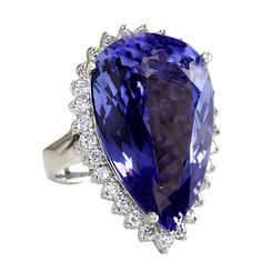 Stamped: 14KRing Size: 6.75Total Ring Weight: 10 GramsDiamond Weight: Total natural diamond weight is 1.10carat. SI1-SI2 clarity / G-H colorGemstone Weight: Total Natural Tanzanite Weight is 22.22ctw (Measures: 24.83x15.52mm) VVSFace Measures: 29.17x19.05mmMain stone color: Blue [SKU:702912] Luxury Tanzanite Diamond Ring With Brilliant Cut, Luxury Tanzanite Rings For Formal Occasions, Elegant Pear-shaped Gemstones For Formal Occasions, Luxury Formal Tanzanite Ring, Luxury Tanzanite Diamond Ring Round Cut, Luxury Tanzanite Diamond Ring With Halo Setting, Luxury Tanzanite Diamond Ring With Round Cut, Luxury Tanzanite Diamond Ring For Formal Occasions, Luxury Round Cut Tanzanite Diamond Ring