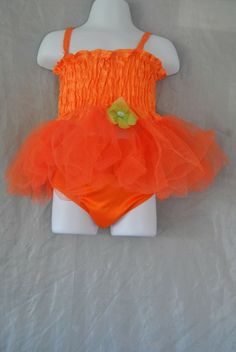 Toddler dress size 6-12 months, orange in color and has a green flower on the front. The dress slips overhead the dress is sleeveless. The bottom of the dress has lace all around it. Comes with underpants orange in color. For more great items please visit us at:https://www.ebay.com/str/maggieandsampson6 Fitted Cotton Tutu Dress For Summer, Orange Summer Party Tutu Dress, Orange Summer Dress For Dress-up, Orange Summer Dress For Dress-up Occasion, Orange Summer Dresses For Casual Wear, Dress Orange, Green Flower, Toddler Dress, Green Flowers