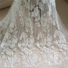 a white wedding veil with flowers on it