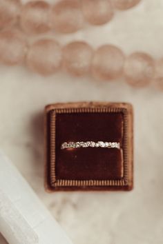 an engagement ring sitting in a box on top of a table