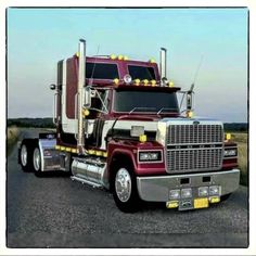 a large semi truck driving down a rural road