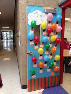 a door decorated with balloons and magnets on the front of a school hallway that says oh the place i'll go