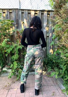 "These Camouflage cotton military pants are marked 1996 and feature a concealed button fly and button cargo flapped hip pockets. 2 slide in front pockets at front. There are stitched air hole vents in the crotch. Nicely broken in with lots of years of wear ahead. Fits like Men's M or Women's M/L/XL or Oversized but please see measurements below for an accurate fit. M E A S U R E M E N T S Waist: 33\" Inseam: 31\" Rise: 12\" Hips: 38\" condition: Good vintage condition. One of the cuff laces is m Fall Combat Wide Leg Cargo Pants, Camouflage Straight Leg Parachute Pants With Cargo Pockets, Straight Leg Camouflage Parachute Pants With Cargo Pockets, Camouflage Straight Leg Cargo Parachute Pants, Fall Combat Cargo Pants, Military Camouflage Wide Leg Cargo Jeans, Camouflage Military Wide Leg Cargo Jeans, Combat Cotton Cargo Pants For Fall, Fall Military Full Length Cargo Pants