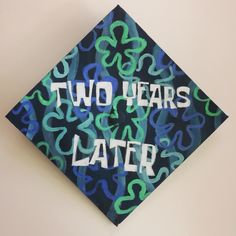 a graduation cap with the words two years later painted on it's front side