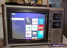 an old sony television sitting on top of a table in front of a shelf with other items