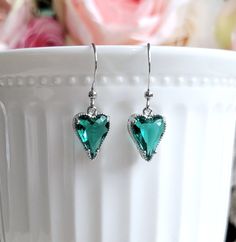 Simple and lovely heart charm necklace and earrings feature teal green Cubic Zirconia pendant/drop in silver setting.  Pendant/drop hang from a dainty silver plated brass chain/earwires.Delightful to wear.  Pendant/drop size: 9 mm x 14 mm (including loop) Total earrings length: 30 mm Purchase over $40 enjoys free shipping! Coupon code 'freeshipping1'.       Free Gift Wrapping on request - All items that are gift wrapped come in with a kraft box with raffia string and blank writing card.  Please leave a note if you need it upon ordering. Green Sterling Silver Jewelry For Valentine's Day, Valentine's Day Green Sterling Silver Jewelry, Green Heart Charm Earrings For Valentine's Day, Green Heart Charm Jewelry For Valentine's Day, Green Heart-shaped Jewelry Gift For Her, Emerald Jewelry With Heart Charm As Gift, Green Heart Charm Jewelry For Anniversary, Green Heart Charm Jewelry For May Birthstone, Green Sterling Silver Heart Jewelry