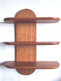 three wooden shelves are mounted to the wall