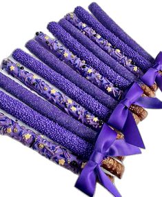 purple beads are tied with a bow and decorated with gold flecks on them