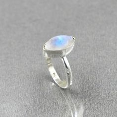 Rainbow Moonstone Ring, Sterling Silver, Moonstone Ring, Marquise Moonstone Ring, Boho Ring, Gemstone Ring, Silver Moonstone Ring, Gifts ---------------------------------------------------------------------------------------------------------------------------------------------------- Style- Solid 925 Sterling Silver Ring Gemstone- Natural White Rainbow Moonstone Shape - Marquise Cabochon Stone Size - 7x14 MM Weight- 2.50 Grams Approx ------------------------------------------------------------- Moon Shaped Moonstone Ring With Natural Stones, Moonstone Open Ring With Natural Stones, Open Ring Moonstone With Natural Stones, Open Moonstone Ring With Natural Stones, Natural Stones Moonstone Open Ring, Natural Moonstone Open Ring, Spiritual Moon-shaped Moonstone Ring, Gemstone Ring Silver, Moonstone Ring Sterling Silver