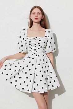 Our French Summer Polka Dot Puff Sleeve Dress, with its square neckline and pleated design, is a classic choice for the season Step out in our French Summer Polka Dot Puff Sleeve Dress. The black and white dress features a square neckline, puff sleeves, and a pleated skirt for an elegant yet fun summer style. The polka dot design adds a vintage touch, making this a must-have piece for your summer wardrobe. Style#: WWSI340 Simple Prom Dress Short, White Frock, Indian Dresses For Women, Vintage Polka Dot Dress, French Summer, Polka Dots Outfit, Shrug For Dresses, Frock For Women, Aesthetic Dress