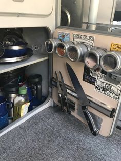 the inside of an airplane kitchen with knives and other cooking utensils in it