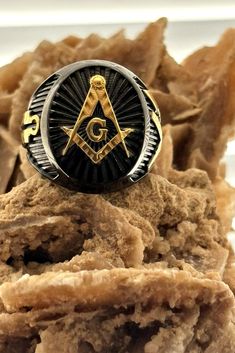 a masonic ring sitting on top of some food