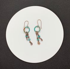 Beautiful turquoise blue Patinated Copper with hammered copper and dyed Howlite Dangles. On handmade Copper Ear wires. I think these earring would look great with this necklace: https://monkeyliondesigns.com/collections/necklace/products/patinated-copper-and-howlite-necklace An original Monkeylion Design.Approximately 2 5/16" long and 5/8" wideThese earrings have been antiqued, polished and sealed.Sealed with Protectaclear ProtectaClear is a clear, protective coating that is tough enough to prot Blue Artisan Copper Earrings, Artisan Blue Copper Earrings, Turquoise Artisan Electroformed Earrings, Artisan Drop Earrings With Patina, Blue Hand Forged Bohemian Earrings, Blue Bohemian Hand Forged Earrings, Artisan Turquoise Copper Earrings, Artisan Turquoise Earrings In Copper, Artisan Hand Forged Blue Earrings