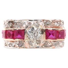 An Art Deco diamond, ruby, platinum, and rose gold ring, comprising one large old European cut diamond, sixteen smaller rose cut diamonds, and eight square and rectangular cut rubies, set in platinum, to a 14 karat rose gold band. This sensational ring is set to the centre with a round, old European cut diamond. The diamond is held within a platinum setting, enhancing the sparkle of the diamond. A row of square cut and rectangular cut rubies extends from the central diamond, held within a rose g Parallel Lines, Channel Setting, Broad Shoulders, Rose Gold Band, Small Rose, European Cut Diamonds, Art Deco Diamond, Ruby Diamond, Square Cut