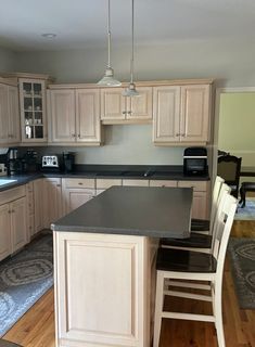 a kitchen with wooden cabinets and black counter tops in the middle of it is shown