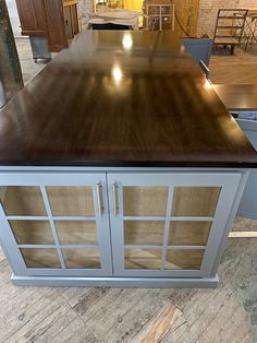 a kitchen island with glass doors on it