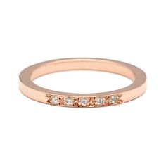 a rose gold wedding band with five diamonds on the inside and outside, set in 18k pink gold