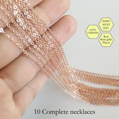 there is a hand that has some beads on it and the words, 10 complete necklaces