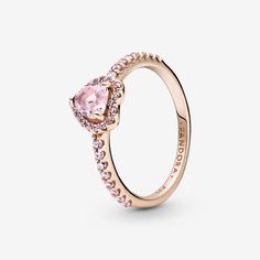 a ring with pink stones on the side and a heart shaped stone in the middle