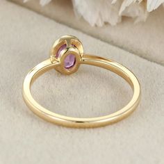 Oval Cut Amethyst Bezel Ring—a stunning and elegant choice that beautifully showcases the deep and regal purple hue of an oval-cut amethyst gemstone set in the luxurious embrace of 14k yellow gold. This ring is a celebration of your unique style and a promise of timeless elegance. Elegant Purple Gemstone Birthstone Ring, Elegant Yellow Gold Amethyst Ring With Halo Setting, Elegant Purple Amethyst Birthstone Ring, Elegant Purple Ruby Ring Round Shape, Elegant Gold Amethyst Ring With Halo Setting, Elegant Purple Ruby Ring Round Cut, Elegant Lavender Amethyst Ring, Elegant Amethyst Bezel Set Oval Cabochon Ring, Elegant Purple Amethyst Ring With Bezel Setting