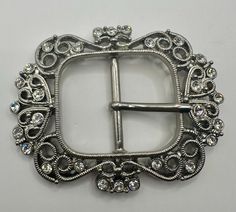 a silver buckle with crystal stones on it