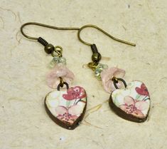 These are pretty pink and red heart earrings are paired with pink and green Czech beads and antique bronze ear wires.  I love the handmade ceramic red, pink flowers on the hearts. The ceramic hearts are by British artisan Natalie McKenna of Grubbi.   They are light and comfortable on the ears.  The casual earrings hang about 1.75 inches in length.    They make a lovely birthday present, Christmas gift or Valentine gift. All of my jewelry is shipped in eco friendly craft boxes wrapped with a bow. Pink Heart-shaped Flower Earrings For Gift, Pink Heart-shaped Flower Earrings As Gift, Vintage Pink Heart Earrings For Valentine's Day, Ceramic Hearts, Craft Boxes, Jewelry Ceramic, Red Heart Earrings, Broken China Jewelry, Casual Earrings