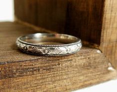 a wedding ring sitting on top of a wooden box