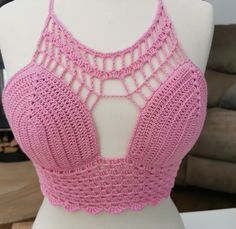 a pink crocheted bralet on a mannequin