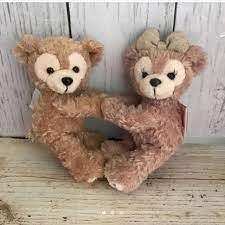 two brown teddy bears sitting next to each other