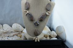 "This is the perfect option for those who like cool, unique jewelry and the luxury, shine of silver, brown. This necklace is well made, cute and/or elegant in design, and very desirable. Its style is a Sautoir, with its beautiful Petrified Wood stones and 4 dangles of genuine champagne pearls hanging 2-1/2 inches from a square bronze glass bead. See all our pictures. Going up each side of the main necklace are brownstones with lots of matrices. They are expertly matched on each side, on sterling Elegant Brown Jewelry With Silver Beads, Brown Spiritual Dangle Jewelry, Elegant Brown Natural Stone Jewelry, Brown Jewelry With Unique Variations And Round Beads, Brown Jewelry With Silver Round Beads, Brown Polished Beads Jewelry Gift, Unique Sterling Silver Jewelry With Polished Beads, Unique Brown Jewelry With Polished Beads, Amber Jewelry With Polished Beads For Gifts