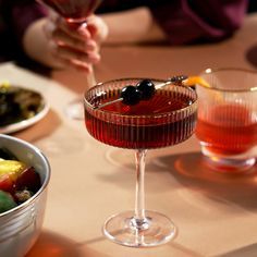 a table topped with bowls and glasses filled with food